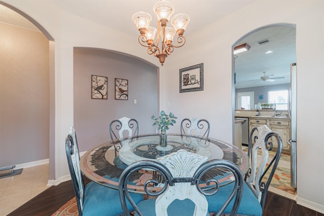 2238 Sterling Oaks Dr, Rosharon, TX 77583 - dining space featuring arched walkways, a ceiling fan, a chandelier, and wood finished floors