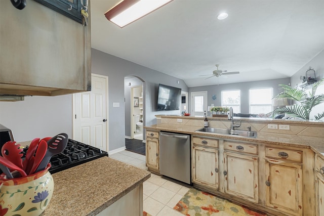 2238 Sterling Oaks Dr, Rosharon, TX 77583 - kitchen with stainless steel dishwasher, a sink, arched walkways, ceiling fan, and light brown cabinetry