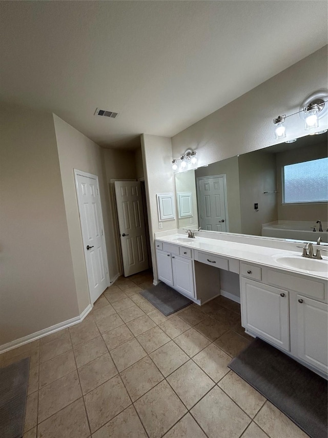 6015 Biltmore Ct, Rosenberg, TX 77471 - full bath with double vanity, tile patterned flooring, a tub, and baseboards