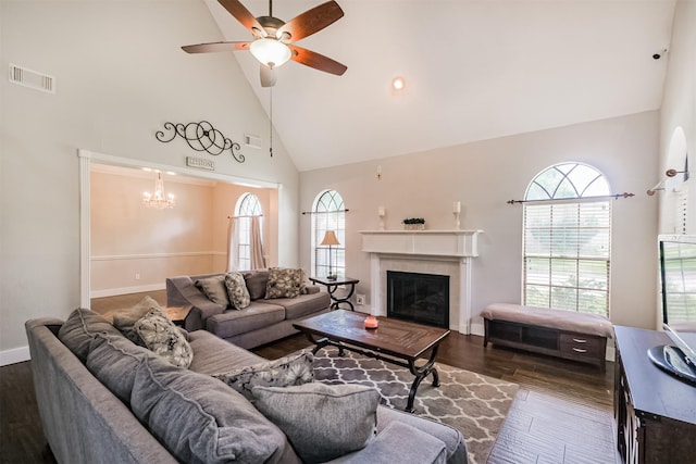 10402 Hondo Hill Rd, Houston, TX 77064 - living room with high vaulted ceiling, healthy amount of natural light, dark wood-style floors, a ceiling fan, and a chandelier
