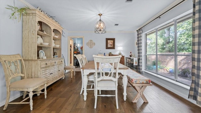 1925 Foxbriar Dr, Huntsville, TX 77340 - dining room featuring crown molding, dark wood-style flooring, a chandelier, and baseboards