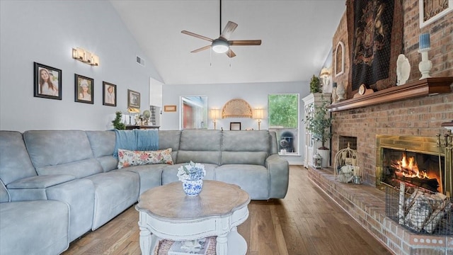 1925 Foxbriar Dr, Huntsville, TX 77340 - living room featuring ceiling fan, wood finished floors, a brick fireplace, and high vaulted ceiling