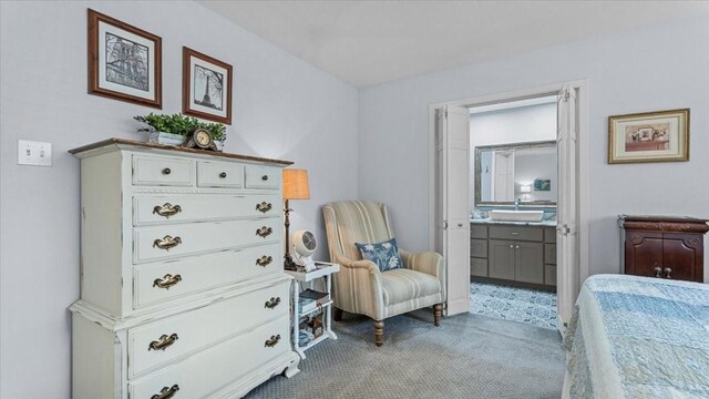 1925 Foxbriar Dr, Huntsville, TX 77340 - carpeted bedroom featuring ensuite bathroom and a sink