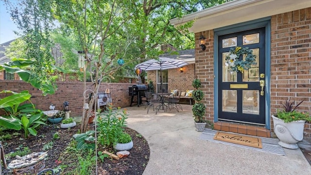 1925 Foxbriar Dr, Huntsville, TX 77340 - doorway to property with brick siding and a patio