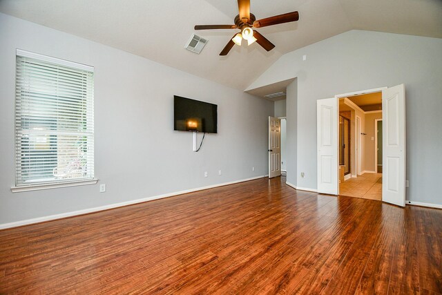 1638 Brookstone Ln, Sugar Land, TX 77479 - unfurnished living room featuring a ceiling fan, wood finished floors, vaulted ceiling, healthy amount of natural light, and baseboards