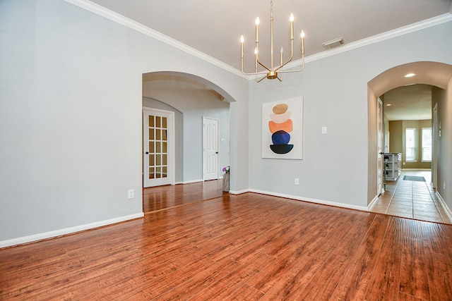 1638 Brookstone Ln, Sugar Land, TX 77479 - empty room with wood finished floors, ornamental molding, a chandelier, and baseboards