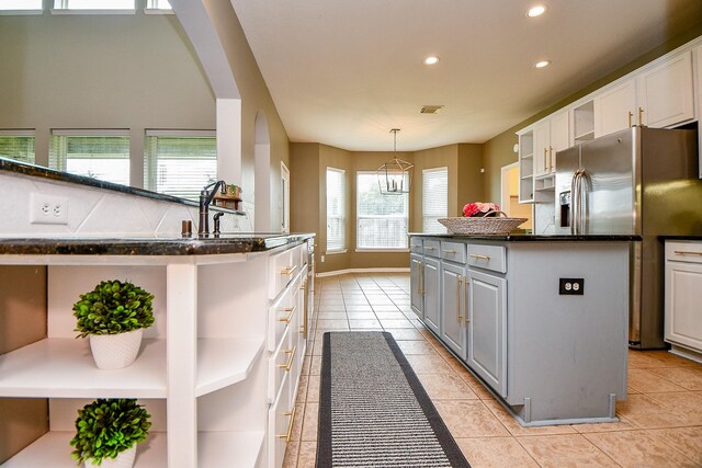 1638 Brookstone Ln, Sugar Land, TX 77479 - kitchen featuring open shelves, stainless steel fridge, recessed lighting, white cabinetry, and a center island
