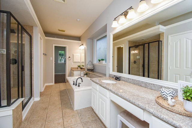 1638 Brookstone Ln, Sugar Land, TX 77479 - bathroom featuring a shower stall, vanity, a garden tub, tile patterned flooring, and baseboards