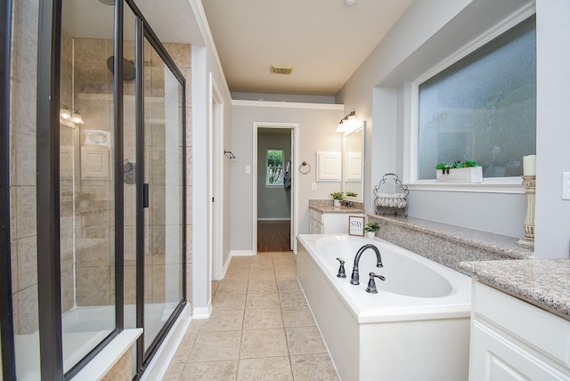 1638 Brookstone Ln, Sugar Land, TX 77479 - bathroom with a stall shower, vanity, a garden tub, tile patterned flooring, and baseboards