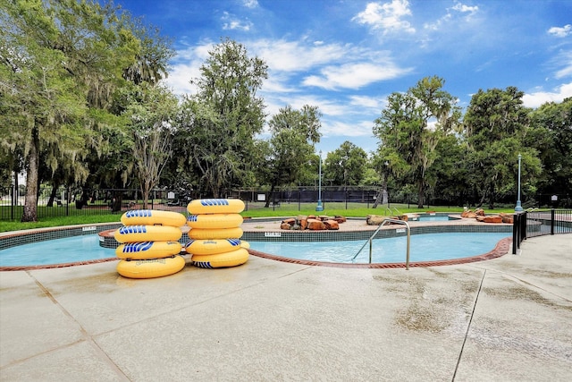 1638 Brookstone Ln, Sugar Land, TX 77479 - community pool featuring a hot tub, view of wooded area, and a patio area