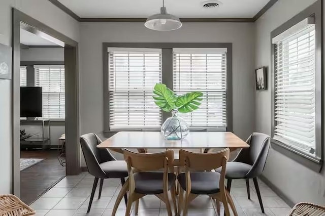 1017 Milner, College Station, TX 77840 - dining room featuring healthy amount of natural light, ornamental molding, light tile patterned flooring, and baseboards