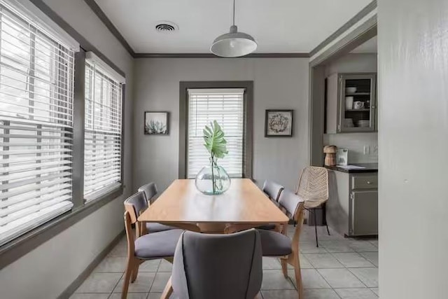 1017 Milner, College Station, TX 77840 - dining area with healthy amount of natural light, light tile patterned flooring, and ornamental molding