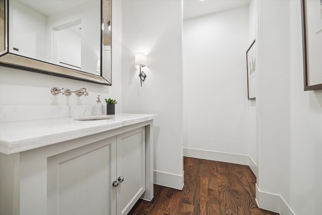 523 E 23rd St, Houston, TX 77008 - bathroom featuring vanity, wood finished floors, and baseboards