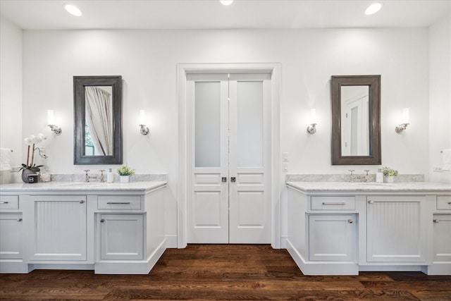 523 E 23rd St, Houston, TX 77008 - full bath with two vanities, wood finished floors, and recessed lighting