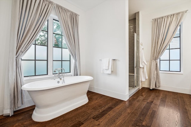 523 E 23rd St, Houston, TX 77008 - bathroom with a soaking tub, baseboards, a stall shower, and wood finished floors