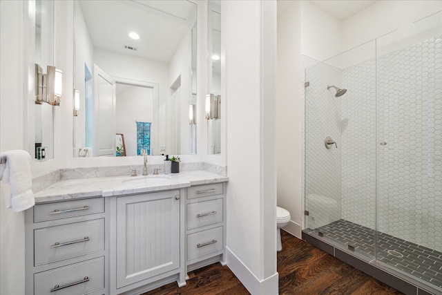523 E 23rd St, Houston, TX 77008 - bathroom with vanity, toilet, a shower stall, and wood finished floors