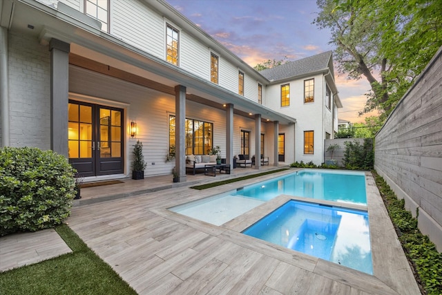 523 E 23rd St, Houston, TX 77008 - rear view of house with an in-ground hot tub, a wooden deck, an outdoor hangout area, french doors, and a fenced backyard