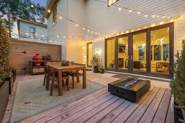 523 E 23rd St, Houston, TX 77008 - wooden terrace with an outdoor fire pit, outdoor dining area, and french doors