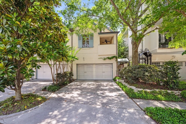 2207 Dunraven Ln, Houston, TX 77019 - view of front of house with stucco siding, concrete driveway, and a garage