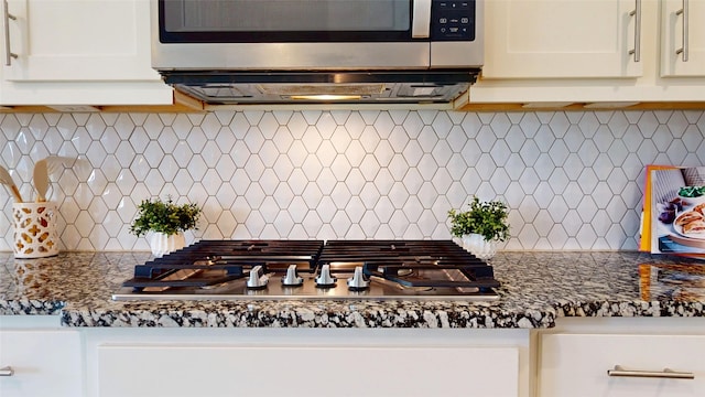 3539 Gore Creek Dr, Katy, TX 77494 - kitchen featuring stainless steel appliances, tasteful backsplash, white cabinets, and dark stone counters