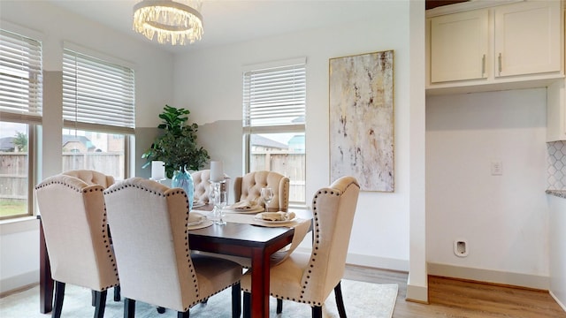 3539 Gore Creek Dr, Katy, TX 77494 - dining room with light wood-type flooring, a chandelier, and baseboards