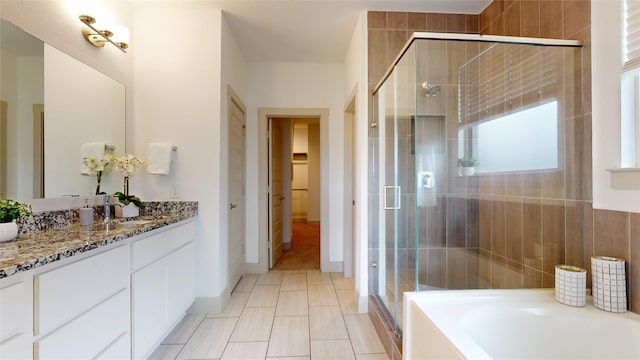 3539 Gore Creek Dr, Katy, TX 77494 - bathroom with vanity, a shower stall, a bath, and baseboards