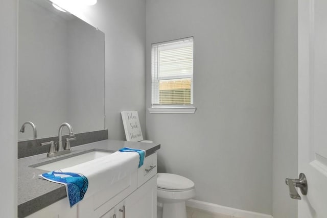 414 Armstrong St, Houston, TX 77029 - bathroom with toilet, vanity, baseboards, and tile patterned floors