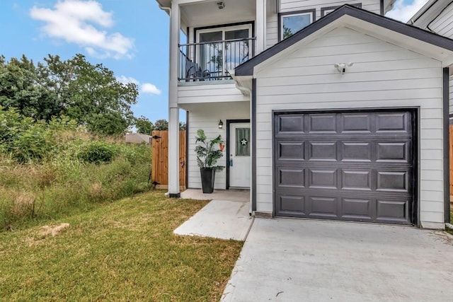414 Armstrong St, Houston, TX 77029 - view of front of property featuring a balcony, driveway, a front lawn, and a garage