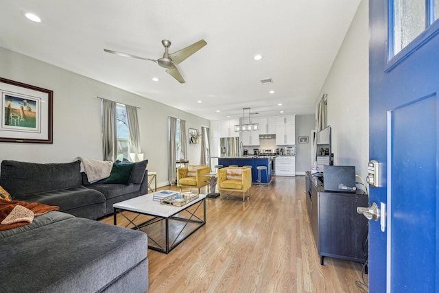 7015 Roswell St, Houston, TX 77022 - living room featuring a ceiling fan, light wood-style floors, and recessed lighting