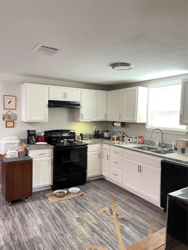 103 Prewitt Ln, West Columbia, TX 77486 - kitchen featuring black appliances, a sink, under cabinet range hood, and white cabinets
