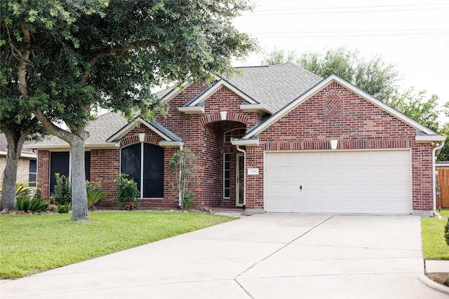 4306 Dow Way, Pasadena, TX 77505 - traditional home featuring concrete driveway, an attached garage, brick siding, a front yard, and roof with shingles