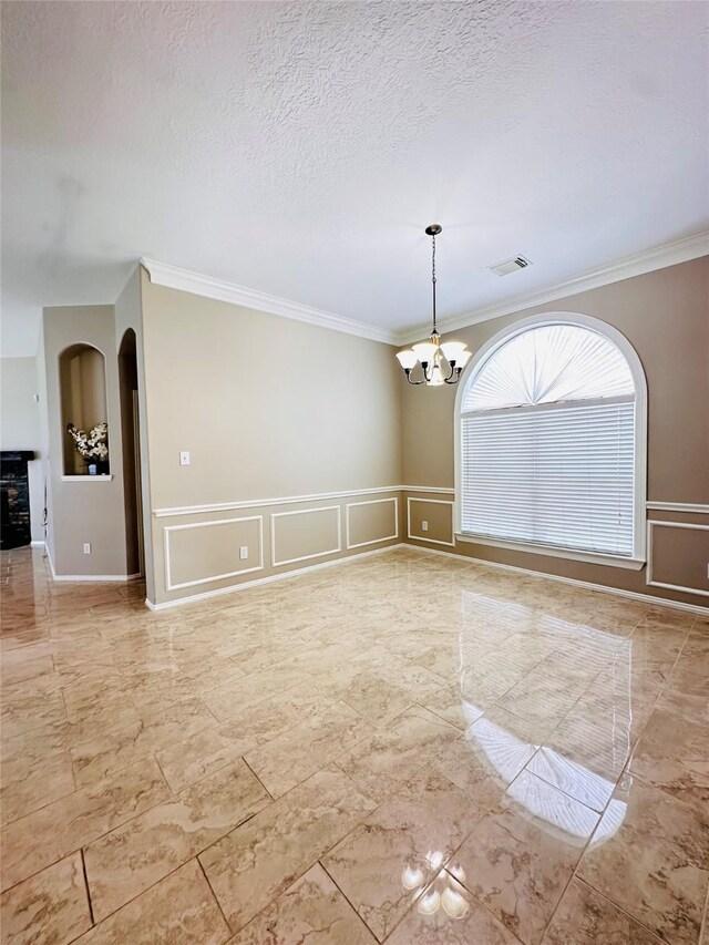 4306 Dow Way, Pasadena, TX 77505 - unfurnished room featuring a chandelier, a decorative wall, crown molding, arched walkways, and marble finish flooring