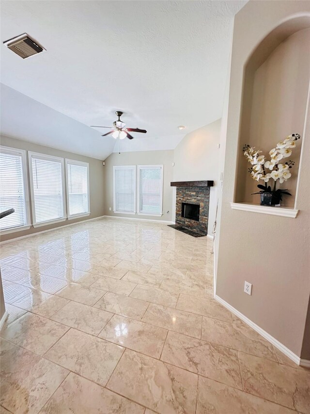 4306 Dow Way, Pasadena, TX 77505 - unfurnished living room featuring a stone fireplace, baseboards, a ceiling fan, and lofted ceiling