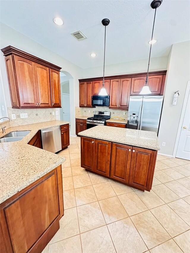 4306 Dow Way, Pasadena, TX 77505 - kitchen featuring appliances with stainless steel finishes, a sink, light tile patterned flooring, decorative backsplash, and arched walkways