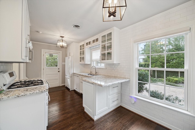 4006 University Blvd, West University Place, TX 77005 - kitchen with white appliances, a sink, dark wood-type flooring, and white cabinets
