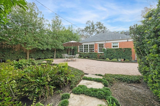 4006 University Blvd, West University Place, TX 77005 - rear view of house featuring brick siding, a patio, and roof with shingles