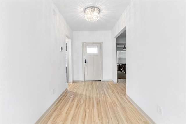 3434 Harper Meadow Ln, Missouri City, TX 77459 - hallway featuring a chandelier, light wood-style flooring, and baseboards
