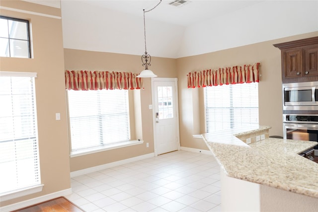 1818 Janell Rene Cir, Deer Park, TX 77536 - kitchen featuring appliances with stainless steel finishes, pendant lighting, baseboards, light stone countertops, and vaulted ceiling
