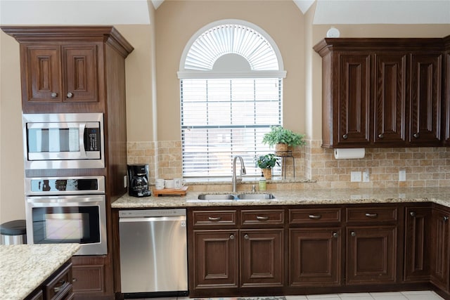 1818 Janell Rene Cir, Deer Park, TX 77536 - kitchen featuring appliances with stainless steel finishes, a sink, backsplash, and dark brown cabinets