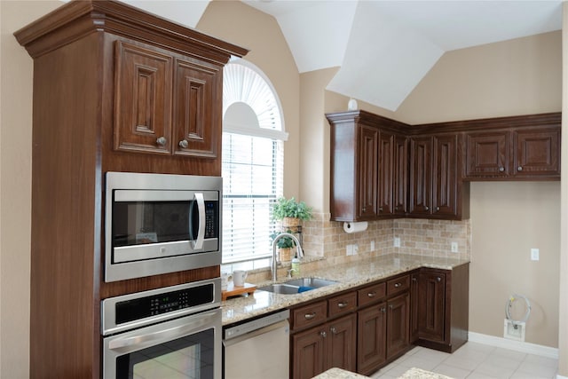 1818 Janell Rene Cir, Deer Park, TX 77536 - kitchen featuring appliances with stainless steel finishes, a sink, light stone countertops, decorative backsplash, and light tile patterned flooring