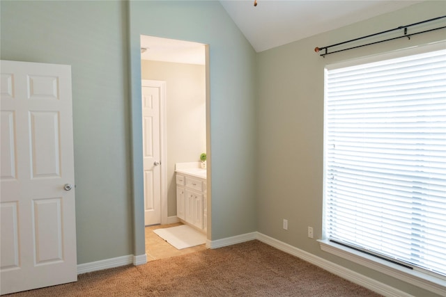 1818 Janell Rene Cir, Deer Park, TX 77536 - unfurnished bedroom featuring light carpet, vaulted ceiling, baseboards, and ensuite bathroom