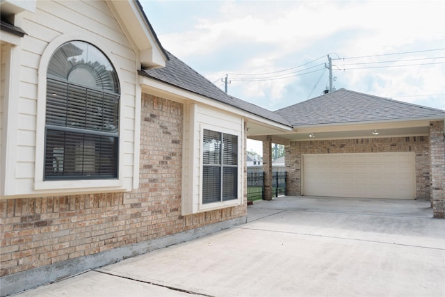 1818 Janell Rene Cir, Deer Park, TX 77536 - view of side of home with brick siding, concrete driveway, a shingled roof, and an attached garage