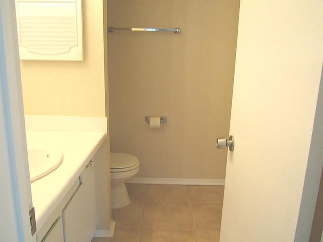 208 Yacht Club Ln, Seabrook, TX 77586 - bathroom with vanity, toilet, tile patterned flooring, and baseboards