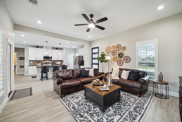 25747 Beaver Run Dr, Huffman, TX 77336 - living area featuring light wood-type flooring, a ceiling fan, baseboards, and recessed lighting