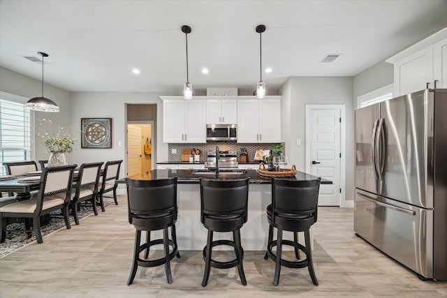 25747 Beaver Run Dr, Huffman, TX 77336 - kitchen with appliances with stainless steel finishes, plenty of natural light, a sink, light wood-style flooring, and recessed lighting