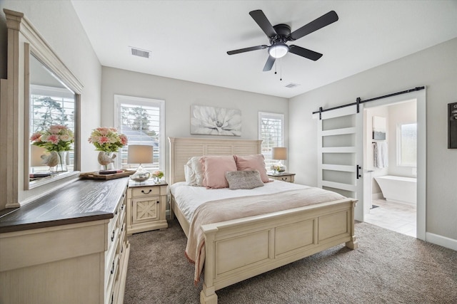25747 Beaver Run Dr, Huffman, TX 77336 - carpeted bedroom with a barn door, ensuite bath, a ceiling fan, and baseboards