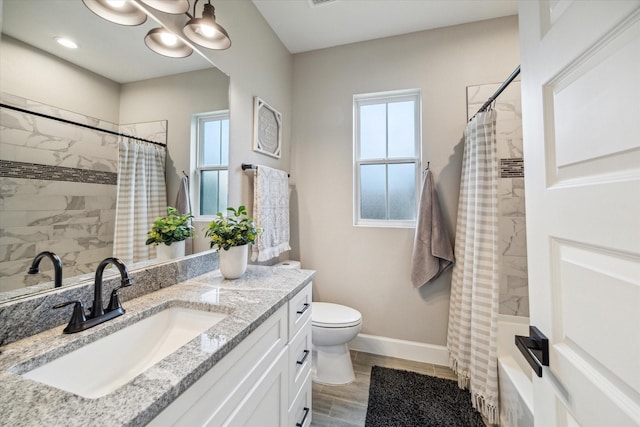 25747 Beaver Run Dr, Huffman, TX 77336 - bathroom with vanity, toilet, wood finished floors, shower / tub combo with curtain, and baseboards