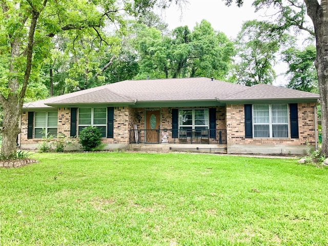 157 Rolling Hills Dr, Conroe, TX 77304 - ranch-style house with covered porch, brick siding, and a front yard