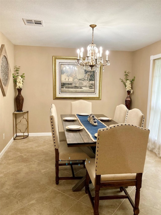 157 Rolling Hills Dr, Conroe, TX 77304 - dining area with a chandelier, light tile patterned floors, baseboards, and a textured ceiling