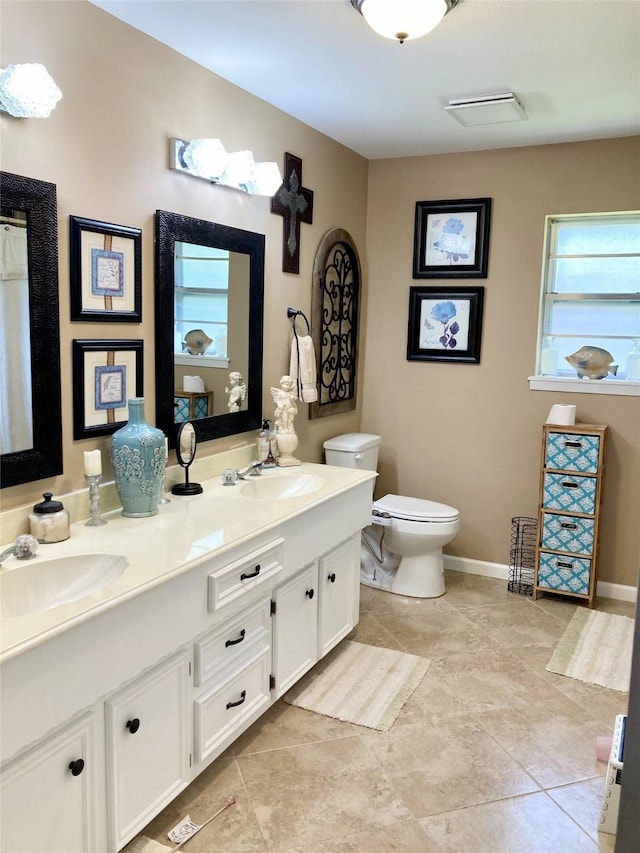 157 Rolling Hills Dr, Conroe, TX 77304 - bathroom featuring double vanity, toilet, and baseboards
